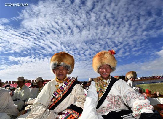 People wearing hats during horse racing festival in Tibet