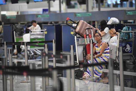 Tourists are stranded due to chaos caused by protesters at Hong Kong International Airport in Hong Kong, south China, Aug. 12, 2019. (Xinhua/Lui Siu Wai)