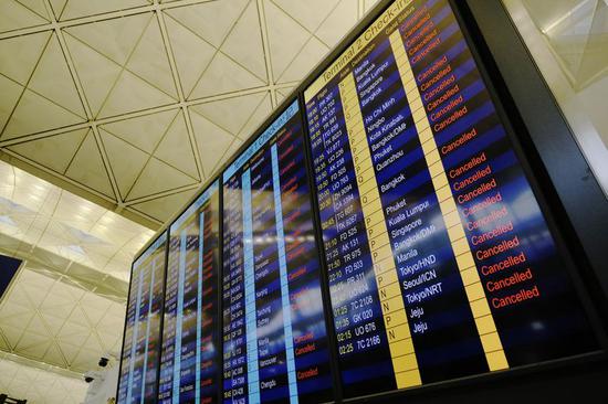 Cancelled flights are shown on a screen at Hong Kong International Airport in Hong Kong, south China, Aug. 12, 2019. (Xinhua/Wang Shen)