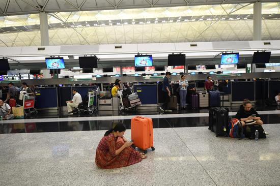 Tourists are stranded due to chaos caused by protesters at Hong Kong International Airport in Hong Kong, south China, Aug. 13, 2019.(Xinhua/Lui Siu Wai)
