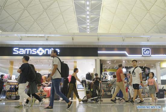 Passengers are seen at Hong Kong International Airport in Hong Kong, south China, Aug. 14, 2019. Airport Authority Hong Kong said earlier Wednesday that it has obtained an interim injunction to restrain persons from unlawfully and willfully obstructing or interfering with the proper use of the airport. (Xinhua/Wang Shen)