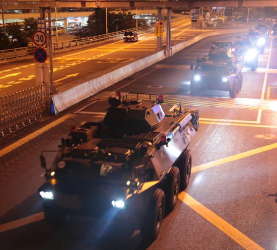Military vehicles of the Chinese People's Liberation Army (PLA) pass Huanggang Port for a routine troop rotation in south China's Hong Kong, Aug. 29, 2019. The Hong Kong Garrison of the Chinese PLA conducted the 22nd rotation of its members in the wee hours of Thursday since it began garrisoning Hong Kong in 1997. (Photo by Yuan Junmin/Xinhua)
