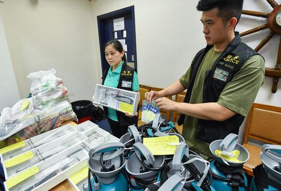 Police show seized suspected counterfeit press cards, axes and corrosive liquids on Sept. 1, 2019 in South China's Hong Kong. (Xinhua)