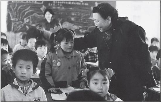 Jiang Lijuan visits a primary school in the Ningxia Hui autonomous region to see the girls she has helped to return to school.