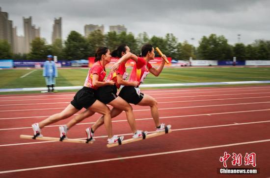 Participants standing on sticks compete in a race during the 11th Chinese Ethnic Games in Zhengzhou, Henan Province, Sept. 11, 2019. More than 7,000 athletes from 34 delegations around China will compete in 17 traditional sports in 140 full events and 194 exhibition events during the nine-day Games that will wrap up on Sept. 16. (Photo: China News Service/Wang Zhongju) Service/Wang Zhongju)