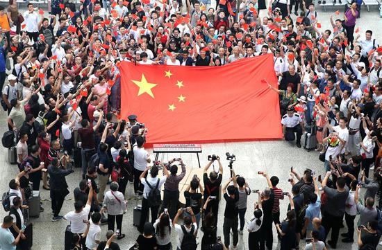 People take part in flash mob in Shanghai to celebrate 70th anniversary of PRC founding