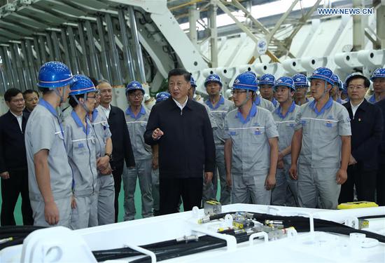 Chinese President Xi Jinping, also general secretary of the Communist Party of China Central Committee and chairman of the Central Military Commission, communicates with workers while inspecting Zhengzhou Coal Mining Machinery Group Co., Ltd. during his tour in Zhengzhou, central China's Henan Province, Sept. 17, 2019. (Xinhua/Ju Peng)