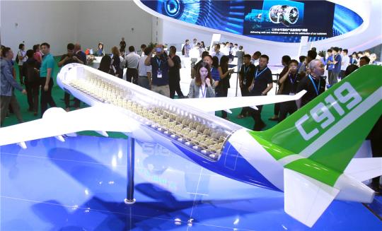 A model of passenger jet C919 is displayed at the Aviation Expo China in Beijing. (Photo by Chen Xiaogen/For China Daily)