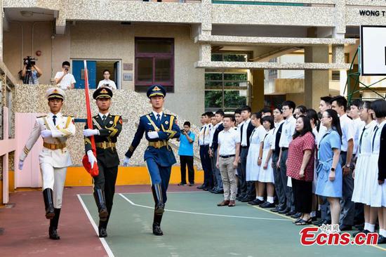 PLA honor guards hold flag-raising ceremony at Hong Kong school