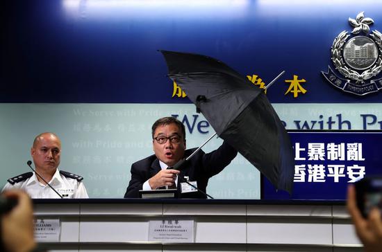 A police spokesman shows one of the weaponized umbrellas rioters used to attack officers, during a police press conference in Hong Kong, south China, Sept. 23, 2019. (Xinhua)