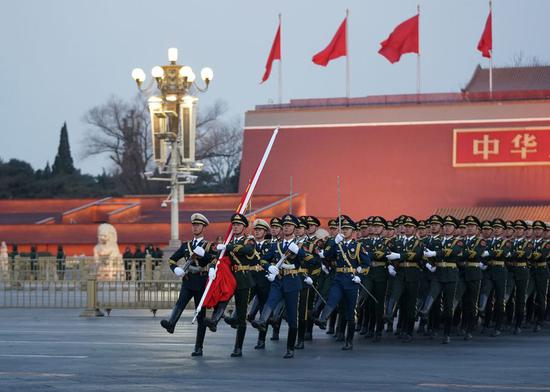 The guard of honor escorts the national flag for a flag-raising ceremony at Tian'anmen Square in Beijing, capital of China, Jan. 1, 2019. (Ju Huanzong/Xinhua)