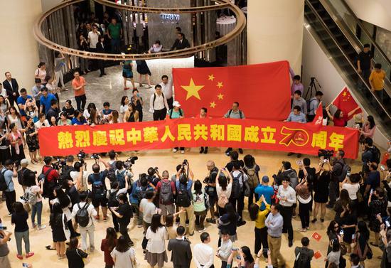 People attend a patriotic flash mob at Pacific Place in Hong Kong, south China, Sept. 24, 2019. Residents sang chorused patriotic songs during the flash mob to celebrate the 70th anniversary of the founding of the People's Republic of China. (Xinhua/Weng Xinyang)
