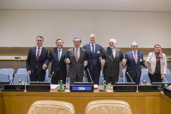 Foreign Minister and State Councilor Wang Yi (L3) poses for a group photo at the UN Ancient Civilizations Forum at the United Nations. (Photo/China News Service)
