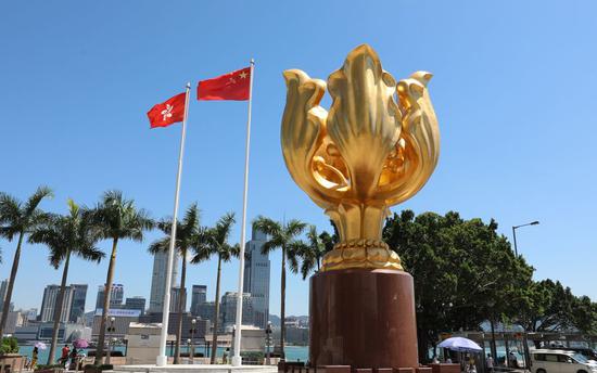 Photo taken on Aug. 5, 2019 shows China's national flag and the flag of the Hong Kong Special Administrative Region (SAR) on the Golden Bauhinia Square in Hong Kong, south China. (Xinhua/Wu Xiaochu)