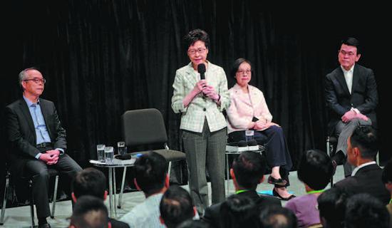 Hong Kong Chief Executive Carrie Lam Cheng Yuetngor speaks at the start of her first community dialogue at Queen Elizabeth Stadium in Wan Chai district on Thursday. (Photo/CHINA DAILY)