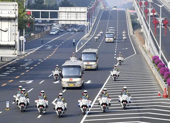 Escorted by a motorcade, awardees of China's national medals and honorary titles head for the Great Hall of the People in Beijing, capital of China, Sept. 29, 2019. (Xinhua/Yan Yan)
