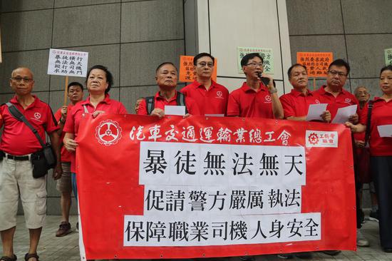 Representatives of Hong Kong Motor Transport Workers General Union assembled in front of the Hong Kong police headquarters to petition the police to curb violence on Oct. 11, 2019. (Xinhua)