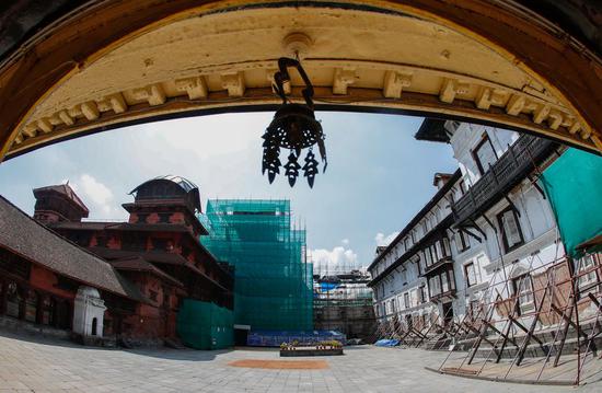 Photo taken on Oct. 9, 2019 shows the restoration site of the nine-storeyed Basantapur complex in at the Durbar Square in Kathmandu, Nepal. (Xinhua/Wang Jingqiang)