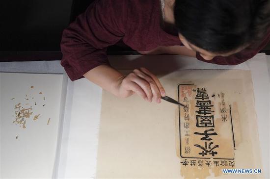 Restorer demonstrate how to restore ancient book in National Library of China