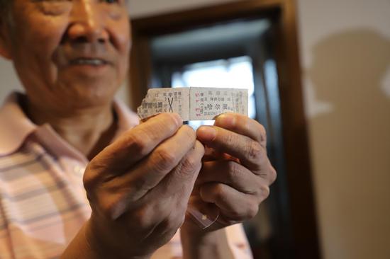 Zhao Yujun displays a ticket in the 1950s, the oldest in his collections, Sept. 24, 2019. (Xinhua/Sun Xiaoyu)