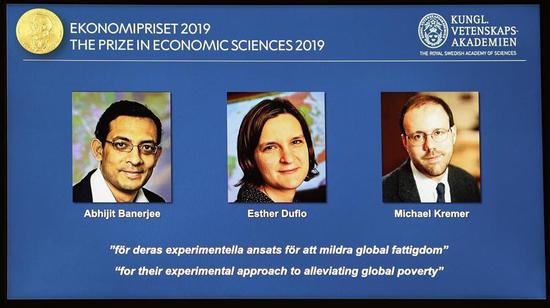 The photos of the winners of the 2019 Nobel Prize in Economics are seen at the Royal Swedish Academy of Sciences, Stockholm, Sweden, Oct. 14, 2019. 