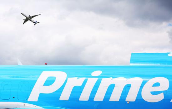 An Airbus A350-000 flies over a 737-800 Boeing Converted Freighter during a flight display at the 53rd International Paris Air Show held at Le Bourget Airport near Paris, France, June 20, 2019. (Xinhua/Gao Jing)