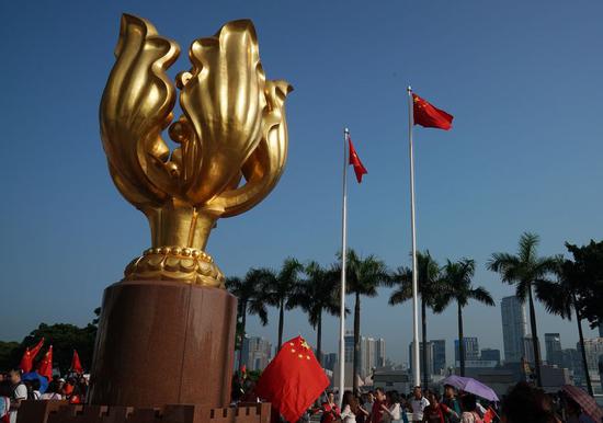 People attend a flag raising ceremony at the Golden Bauhinia Square in Hong Kong on Sept. 8, 2019. (Photo/Xinhua)