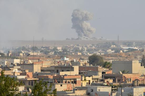 Photo taken on Oct. 9, 2019 shows the northern Syrian city of Ras al-Ain which is under Turkish military attack, as seen from the southern Turkish border town of Ceylanpinar.(Photo by Mustafa Kaya/Xinhua)