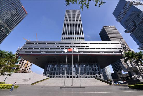 A pedestrian walks past the Shenzhen Stock Exchange building in Shenzhen, Guangdong Province. (Photo provided to China Daily)