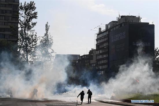 People participate in a protest in Santiago, Chile, Oct. 19, 2019.  (Xinhua/Jorge Villegas)