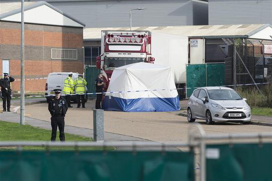 Police officers work at the scene where 39 bodies were found in a shipping container at Waterglade Industrial Park in Essex, Britain, on Oct. 23, 2019. The bodies of 39 people were found Wednesday in a shipping container at an industrial park in Essex, the county bordering London, police confirmed. (Photo by Ray Tang/Xinhua)