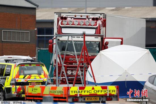 The container lorry where 39 people were found dead inside leaves Waterglade Industrial Park in Grays, Essex, heading towards Tilbury Docks under police escort. (Photo/Agencies)