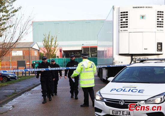 Police officers are seen at the scene where bodies were discovered in a lorry container, in Grays, Essex, Britain October 24, 2019. (Photo/China News Service)