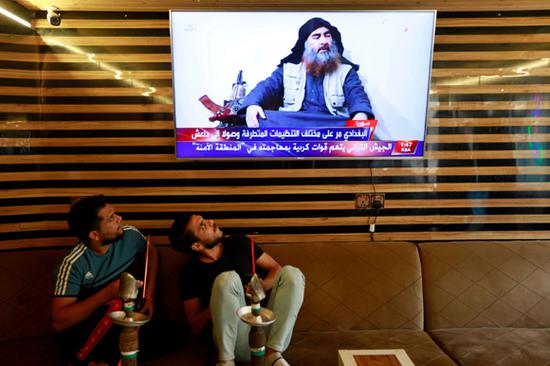 Iraqi youth watch the news of Islamic State leader Abu Bakr al-Baghdadi death, in Najaf, Iraq October 27, 2019. (Photo/Agencies)