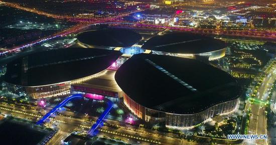 Aerial photo taken on Oct. 27, 2019 shows a night view of the National Exhibition and Convention Center (Shanghai), the venue of the second China International Import Expo (CIIE), in east China's Shanghai. (Xinhua/Ding Ting)