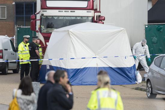 Police officers work at the scene where 39 bodies were found in a shipping container at Waterglade Industrial Park in Essex, Britain, on Oct. 23, 2019. (Photo by Ray Tang/Xinhua)