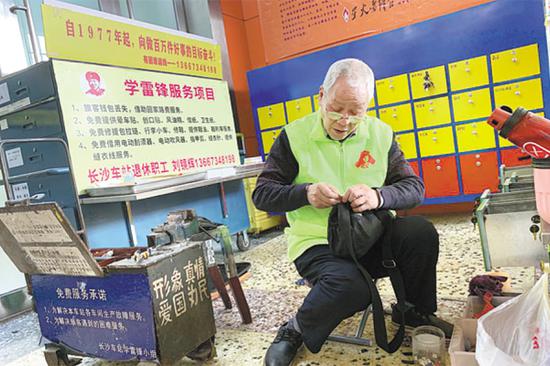 Liu Jinghui sews and mends trousers for a passenger at Changsha Railway Station in Changsha, Hunan province. (LI SIWEN/FOR CHINA DAILY)