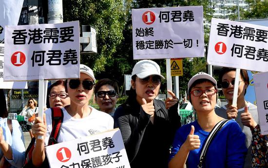 Hong Kong residents show support for Junius Ho, candidate in the upcoming district council election, at his street stand on Nov. 10, 2019. (Xinhua)