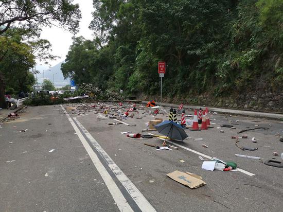 A road is blocked and vandalized by rioters outside the Chinese University of Hong Kong on Nov. 13, 2019. (Xinhua)