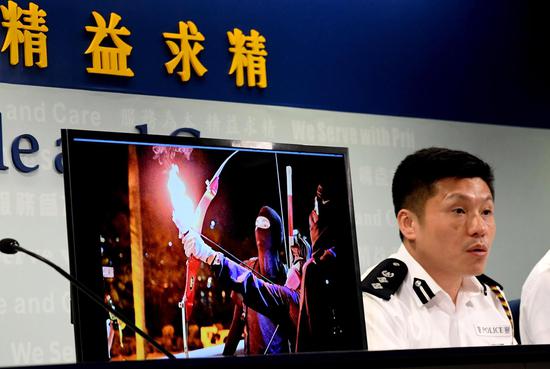 Chief Superintendent of Hong Kong Police Public Relations Branch Tse Chun-chung shows an evidence image of violent acts by rioters at a press conference in Hong Kong, south China, Nov. 13, 2019. (Xinhua/Zhu Xiang)