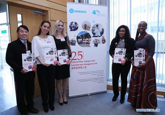 Recipients of the Great Wall Fellowships pose after a ceremony at the UNESCO headquarters in Paris, France, Nov. 13, 2019. China and the UNESCO held a ceremony on Wednesday to mark the 25th anniversary of the Great Wall Fellowships program. (Xinhua/Gao Jing)