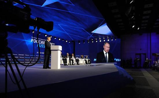 Russian President Vladimir Putin addresses the plenary session of the 
