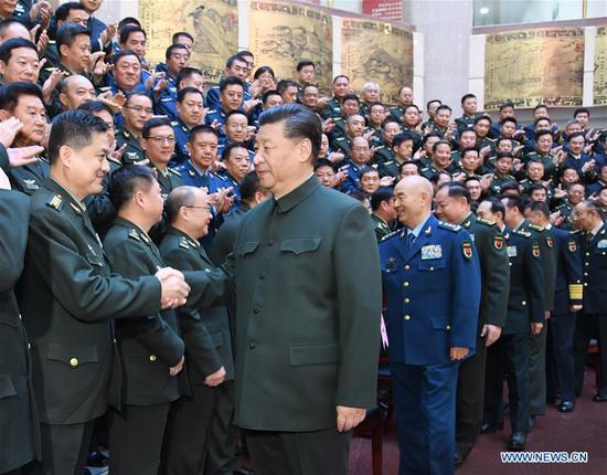 Chinese President Xi Jinping, also general secretary of the Communist Party of China (CPC) Central Committee and chairman of the Central Military Commission, meets with all members of a training session for heads of military academies and schools at the National Defense University of the People's Liberation Army in Beijing, capital of China, Nov. 27, 2019. (Xinhua/Li Gang)