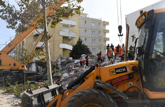 Rescuers search for survivors at a site of a collapsed building in Durres, Albania. (Xinhua/Zhang Liyun)