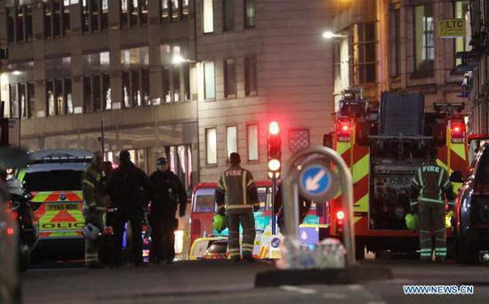 Emergency services work at the scene near London Bridge following an attack in London, Britain, on Nov. 29, 2019. One knifeman was shot dead by police officers at London Bridge on Friday. A number of people were stabbed by the man and the attack was being treated as a terror incident, police said. London Bridge was closed off. Police also said the suspect was wearing a hoax explosive device. (Photo by Isabel Infantes/Xinhua)