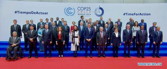 This image grabbed from a video shows delegates posing for a group photo while attending the United Nations Climate Change Conference COP25 in Madrid, Spain, Dec. 2, 2019. The United Nations Climate Change Conference COP25 officially opened here on Monday, where delegates are discussing measures to implement the 2015 Paris Agreement. (Xinhua)