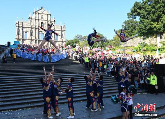 Performers take part in the Macao International Parade in Macao, south China, Dec. 8, 2019. The parade was held to celebrate the 20th anniversary of Macao's return to the motherland.  (Photo/China News Service)