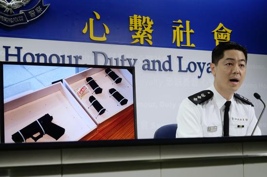 Hong Kong police on Monday show a semi-automatic pistol seized in operation carried out on Sunday. (Xinhua)