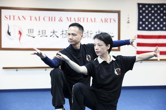 Chen Sitan (L) and his wife Lin Xu perform Tai Chi at Sitan Tai Chi and Martial Arts, a martial art school in Syosset of New York, the United States, Nov. 20, 2019. (Xinhua/Wang Ying)