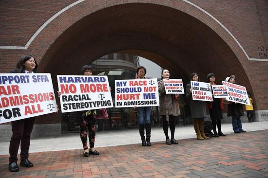 Demonstrators hold slogans in front of John Joseph Moakley United States Courthouse in Boston, Massachusetts, the United States, on Oct. 15, 2018. (Xinhua/Liu Jie)